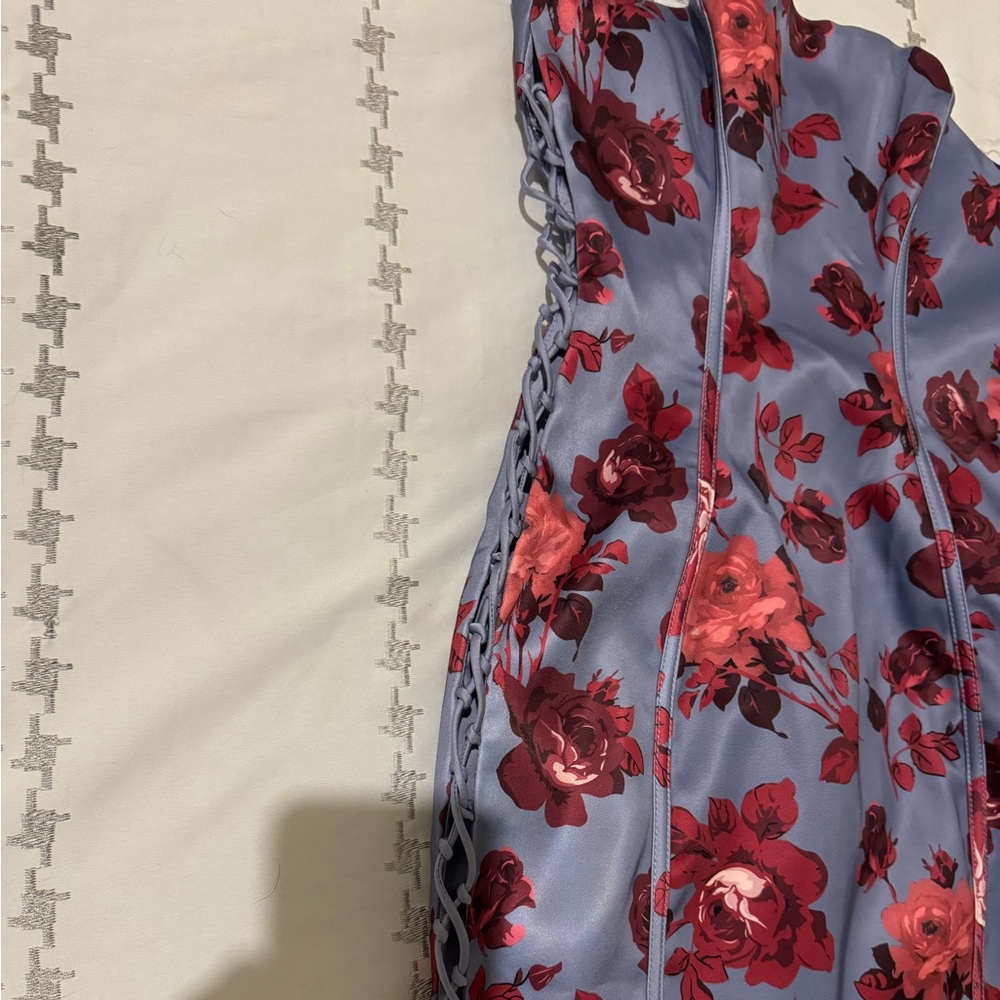 Corset dress in front with opening on the sides.